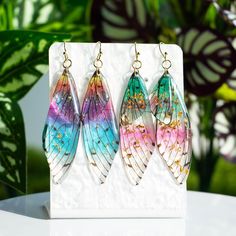 Handmade Resin Jewelry 🦋I love nature's flowers and plants so much! They are so bright, so unique, as beautiful as a fairy. 🦋I like to use hand craftsmanship to preserve their beauty. 🦋Resin earrings are a great design. Hope you will like it. ♥Earring pendant size:About 50mm ♥The ear hook material is 14K gold plated/silver plated. (If you need custom ear hooks, please contact me.✉️ ) 🎁Every package comes with a gift. ★Thank you Butterfly Wing Earrings, Gold Flakes, Wing Earrings, Ear Hook, Butterfly Earrings, Butterfly Wings, Gold Plated Silver, Resin Jewelry, Jewelry Earrings Dangle