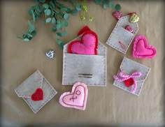 small felt hearts and envelopes on a table