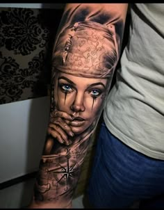 a woman with blue eyes and a hat on her head is shown in this tattoo