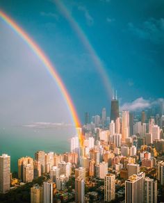 two rainbows are seen over the city skyline in this aerial photo taken from above