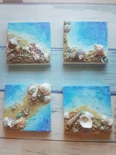 four small seashells are placed on blue and white paper with gold glitter accents