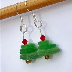 green christmas tree earrings with red bead and silver earwires on white background