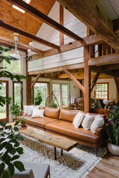 a living room filled with lots of furniture and plants in it's centerpiece