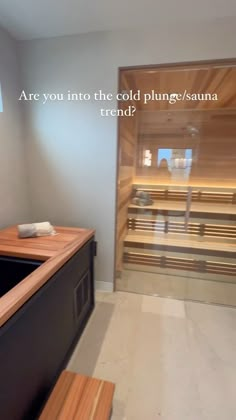 a bathroom with a sink and wooden bench in the corner, next to a sauna tub