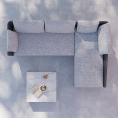 an overhead view of a grey couch and coffee table