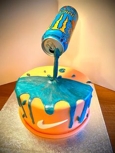 a birthday cake that has been decorated with blue and orange icing on top of it