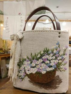 a basket with flowers painted on it sitting on a table