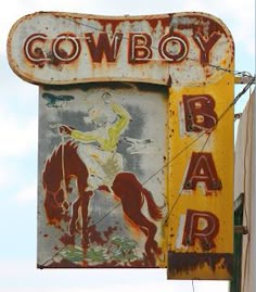 an old neon sign for a bar with a cowboy on it's back side