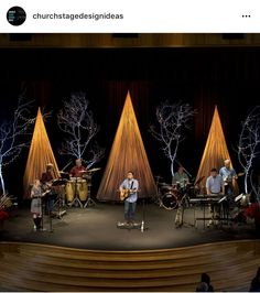 a group of people standing on top of a stage with musical instruments in front of them