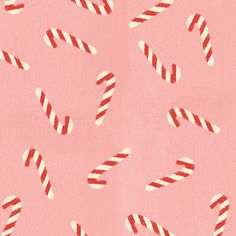 candy canes on a pink background with red and white stripes in the middle,