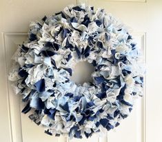 a blue and white wreath hanging on the front door