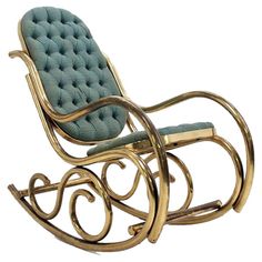 a gold rocking chair with blue upholstered cushions