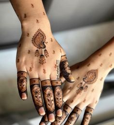 two hands with hendi tattoos on them