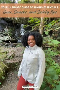 a woman standing in front of a waterfall with the text your ultimate guide to hiking essentials gear, snacks and safety tips