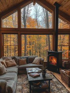 a living room filled with furniture and a fire place in front of a large window