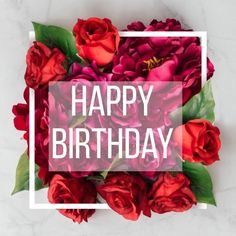 red roses with the words happy birthday in a square frame on a white marble surface