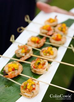 small appetizers are arranged on a banana leaf for an outdoor buffet or party