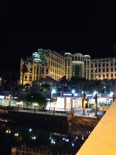 a night view of some buildings and water