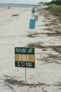 a sign that says reason why i love you on the beach with sea oats