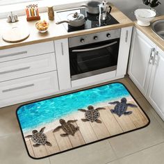 two sea turtles on the beach door mat in front of a kitchen sink and stove