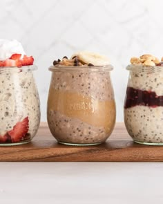 three jars filled with different types of food on top of a wooden table next to each other