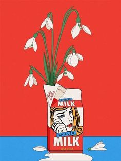 a can of milk with some flowers in it