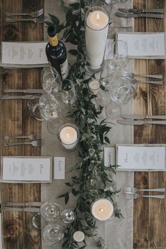 the table is set with candles and place settings