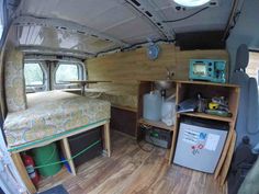 an inside view of a camper with wood flooring and storage compartments on the side