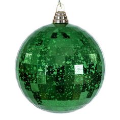 a green ornament hanging on a white background