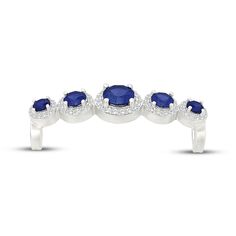 three stone ring in white gold with blue sapphires and diamonds on the sides,