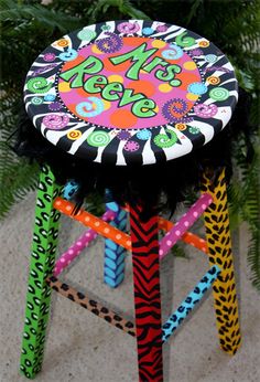 a colorful stool with the word sale on it's side and an animal print seat