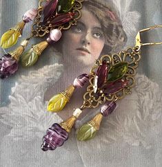 This series is grape related for the oenophile (wine lover). I've been professionally designing jewelry for over 40 years, using only the finest vintage, antique and contemporary components - and always, one of a kind. Most earrings can be converted to posts or clips at no extra charge, just ask ! Materials: Czech Glass, filigree, vintage prong set glass stones, nickel and lead free lever back ear wires Length : 2.5" Shipping via Pirate Ship. International shipping charges are based on clothing Vintage Earrings As Gift, Vintage Dangle Earrings For Vintage Collection, Vintage Drop Earrings For Collection, Vintage Antique Gold Earrings For Gift, Vintage Dangle Earrings From Vintage Collection, Antique Earrings With Vintage Charm For Gift, Handmade Victorian Earrings For Vintage Events, Antique Earrings With Vintage Charm As Gift, Vintage Dangle Earrings