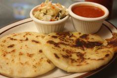 two quesadillas on a plate with salsa and cole slaw