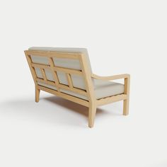 a wooden chair with white cushions on it's back legs and armrests