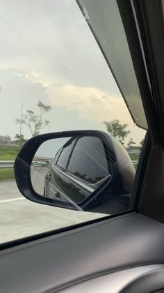 a car's side view mirror on the road