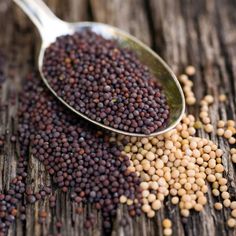 a spoon full of black - eyed peas on top of a wooden table