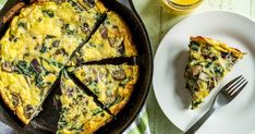 a plate with a slice of quiche next to a fork and glass of orange juice