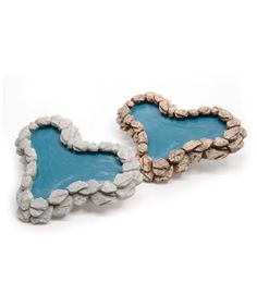 two heart shaped rocks sitting on top of each other