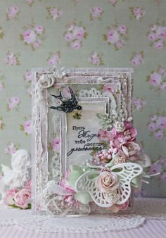 an altered picture frame with flowers and lace on the edge is displayed in front of a wallpapered background