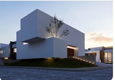 an image of a modern house at sunset or sunrise with stairs leading up to it