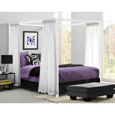 a purple and black bedroom with white drapes