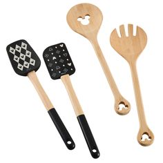 three wooden utensils with black and white designs