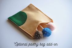 a small pouch with three balls in it and the words optimal party bag add - on