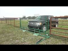 a truck is parked behind a fence in the grass