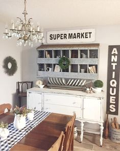 the dining room table is set with place settings and plates on it, along with an antique china cabinet