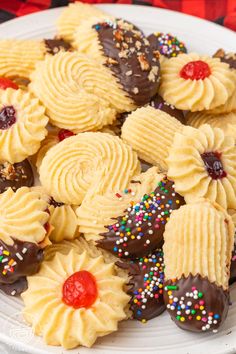 a white plate topped with cookies covered in frosting