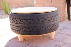 a wooden bench made out of old tires