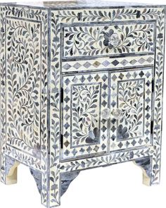 an intricately painted cabinet with drawers and doors on the front, in blue and white