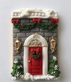 a decorated cookie with a red door and wreath