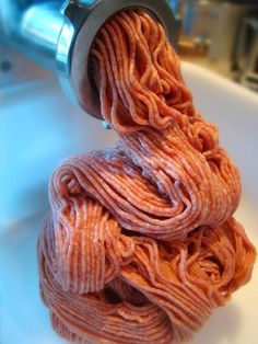 a pile of yarn sitting on top of a bathroom sink next to a faucet